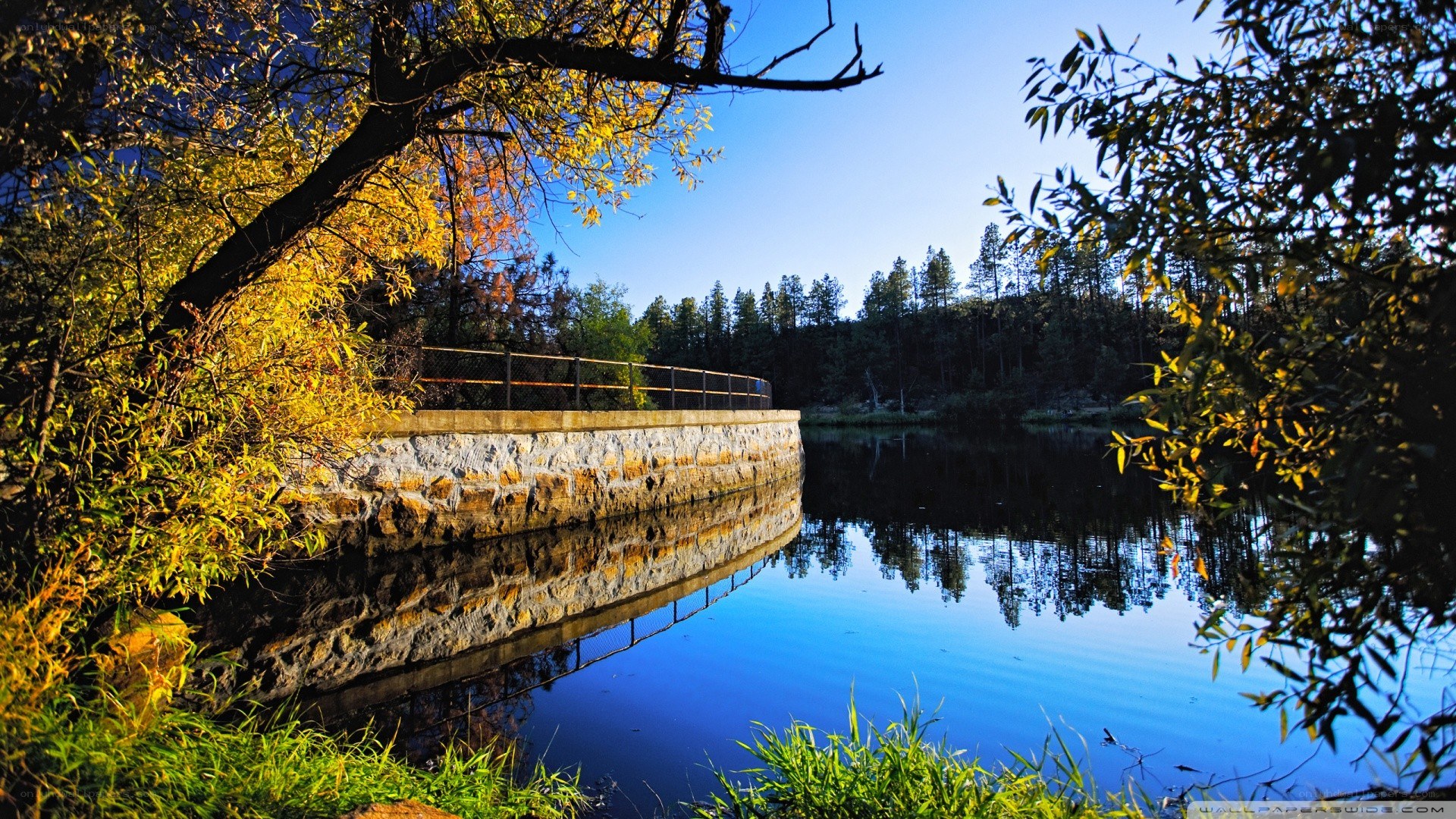 Autumn lake with stone wall