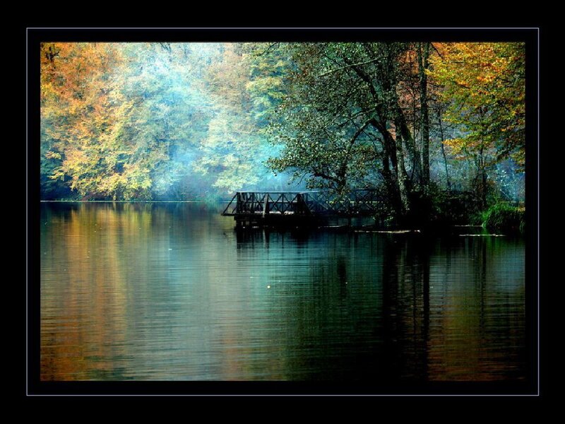 Autumn lake with wooden bridge