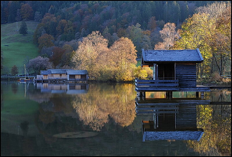 Autumn lake with wooden cabins
