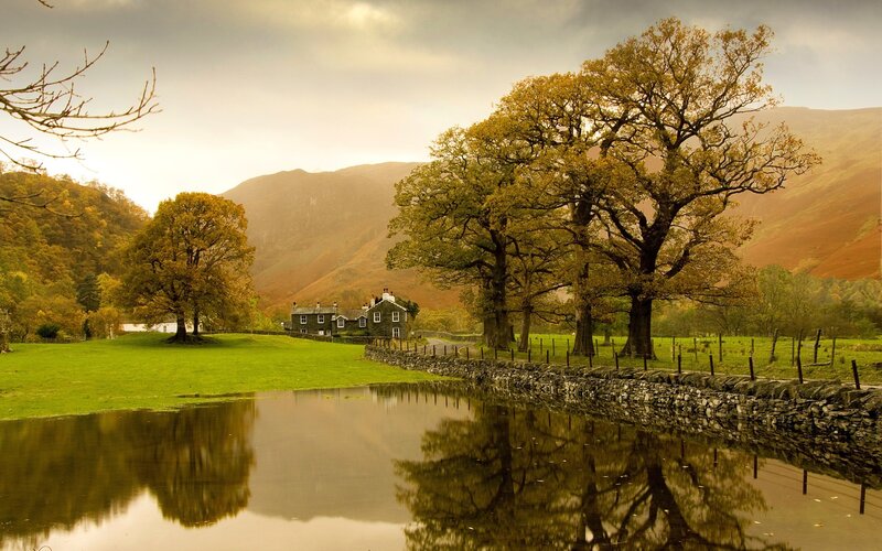 Autumn landscape with lake and cottage