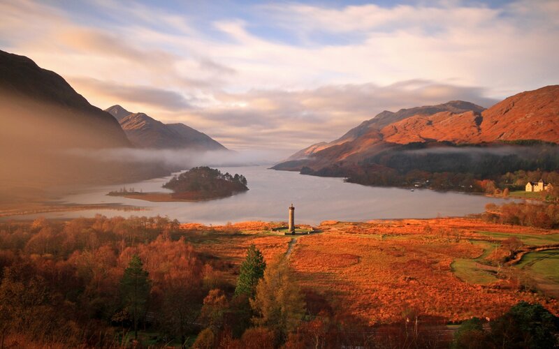 Autumn landscape with lake and monument