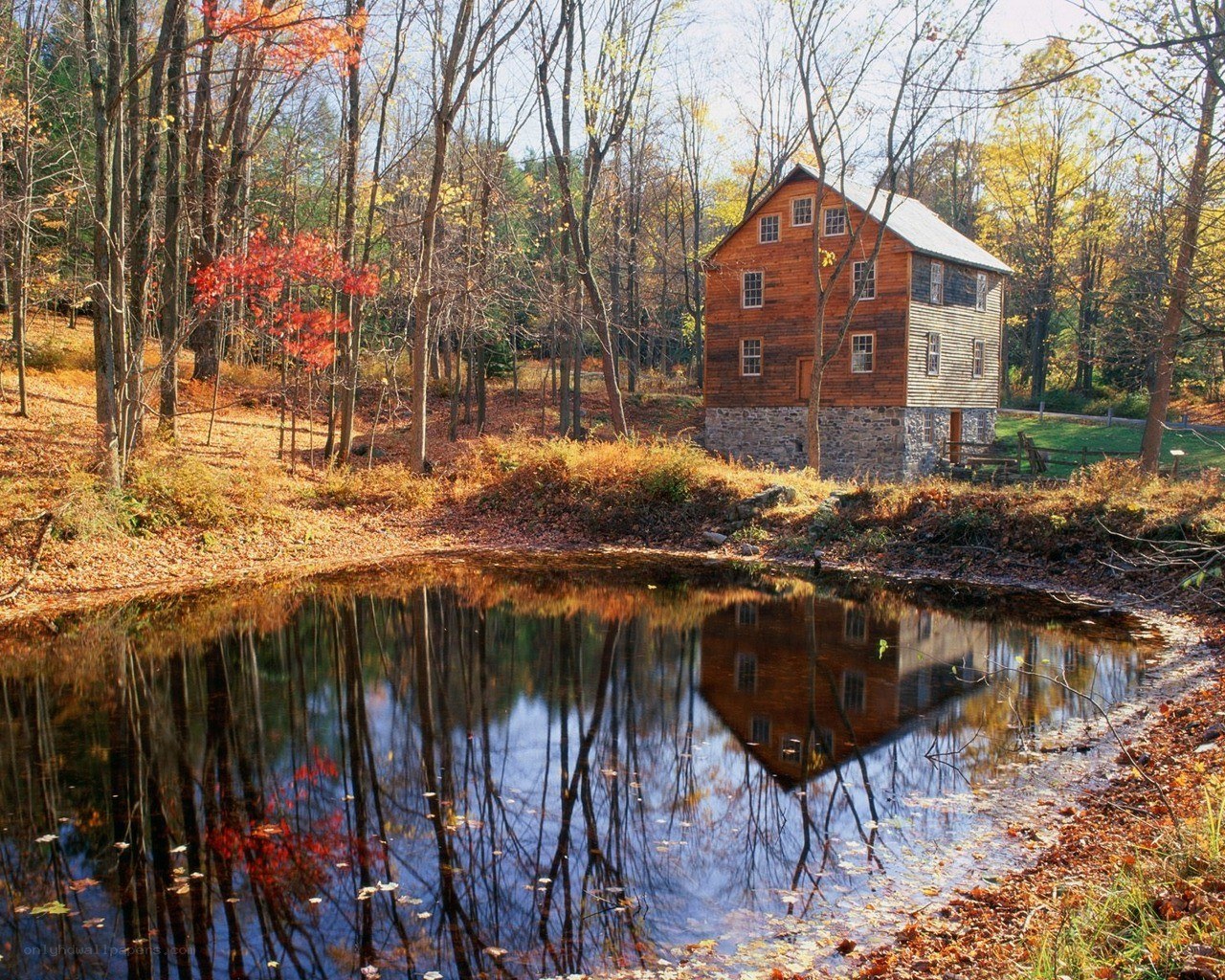 Autumn mill by a pond