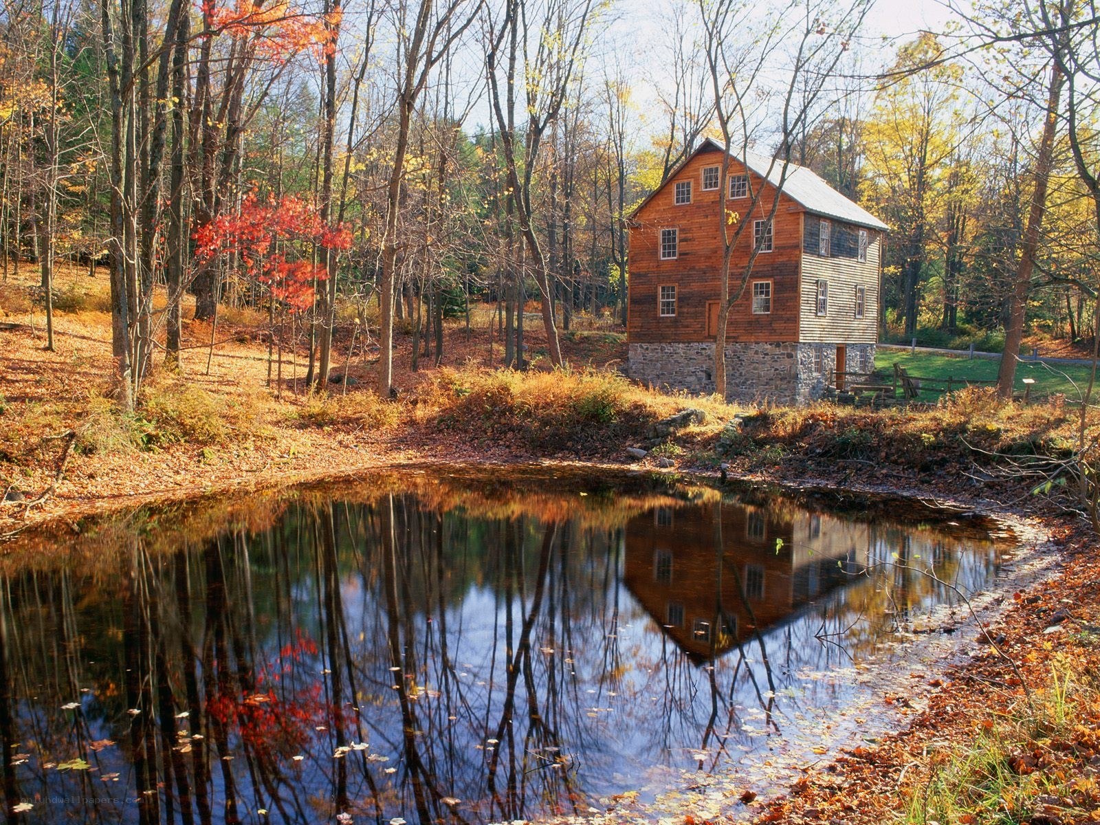 Autumn mill by a pond