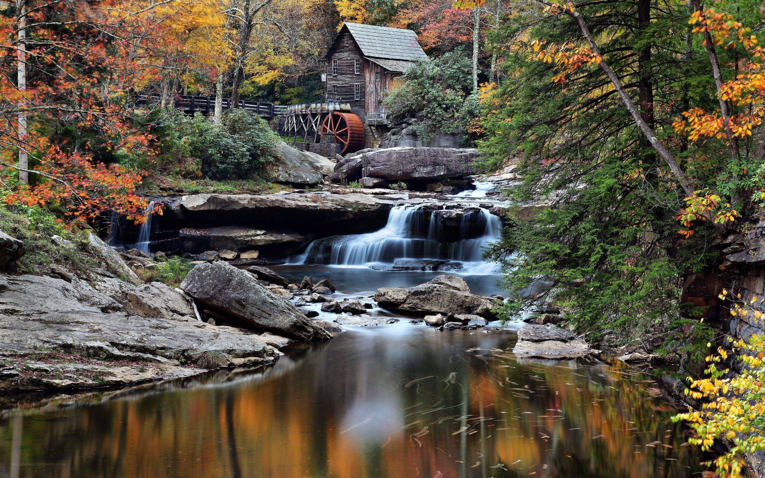 Autumn mill by a waterfall