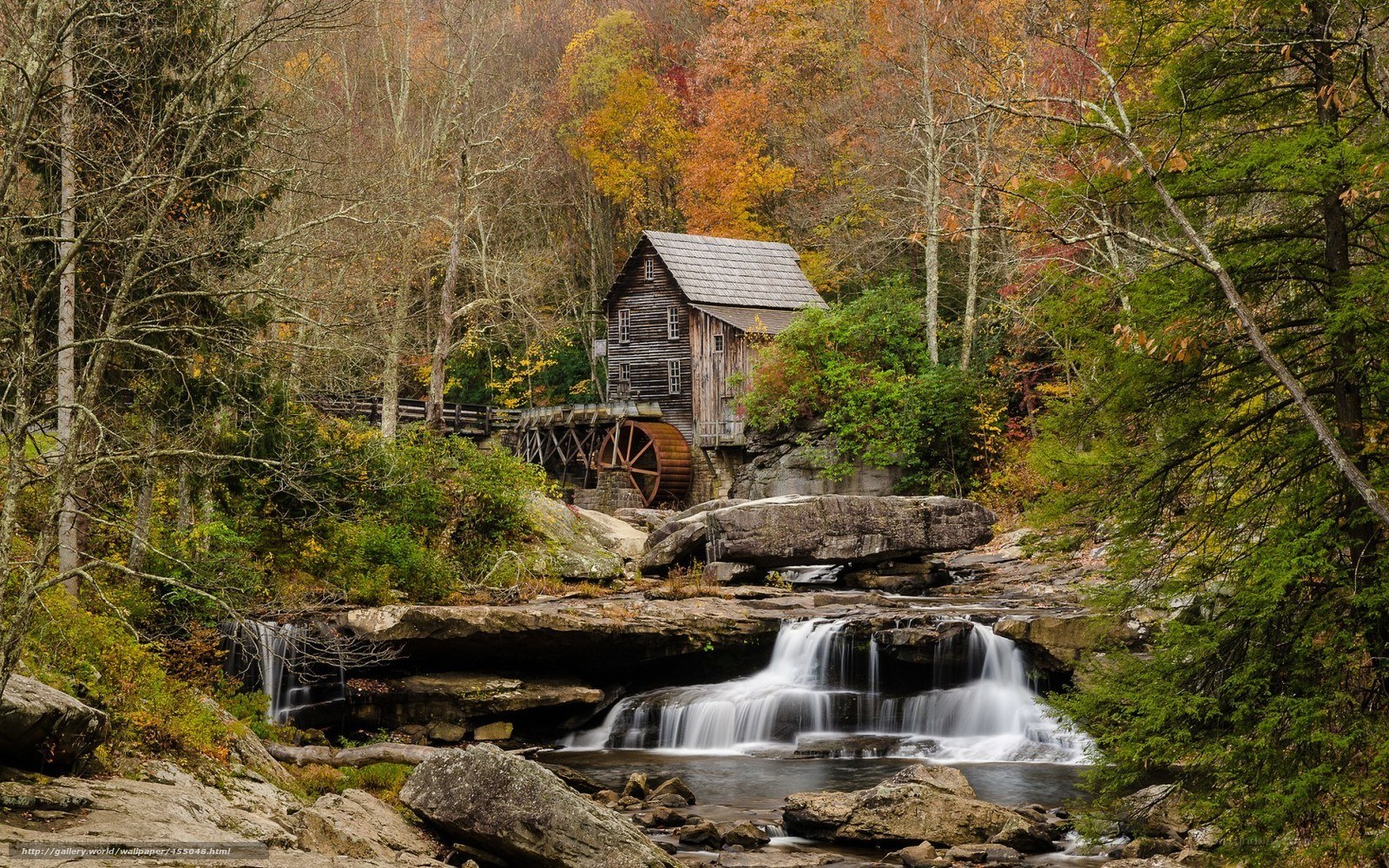 Autumn mill by a waterfall