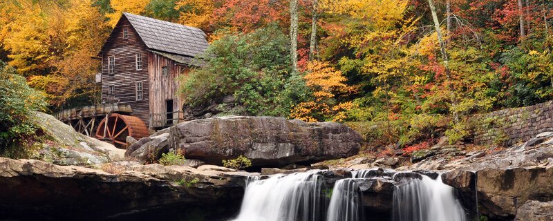 Autumn mill by a waterfall