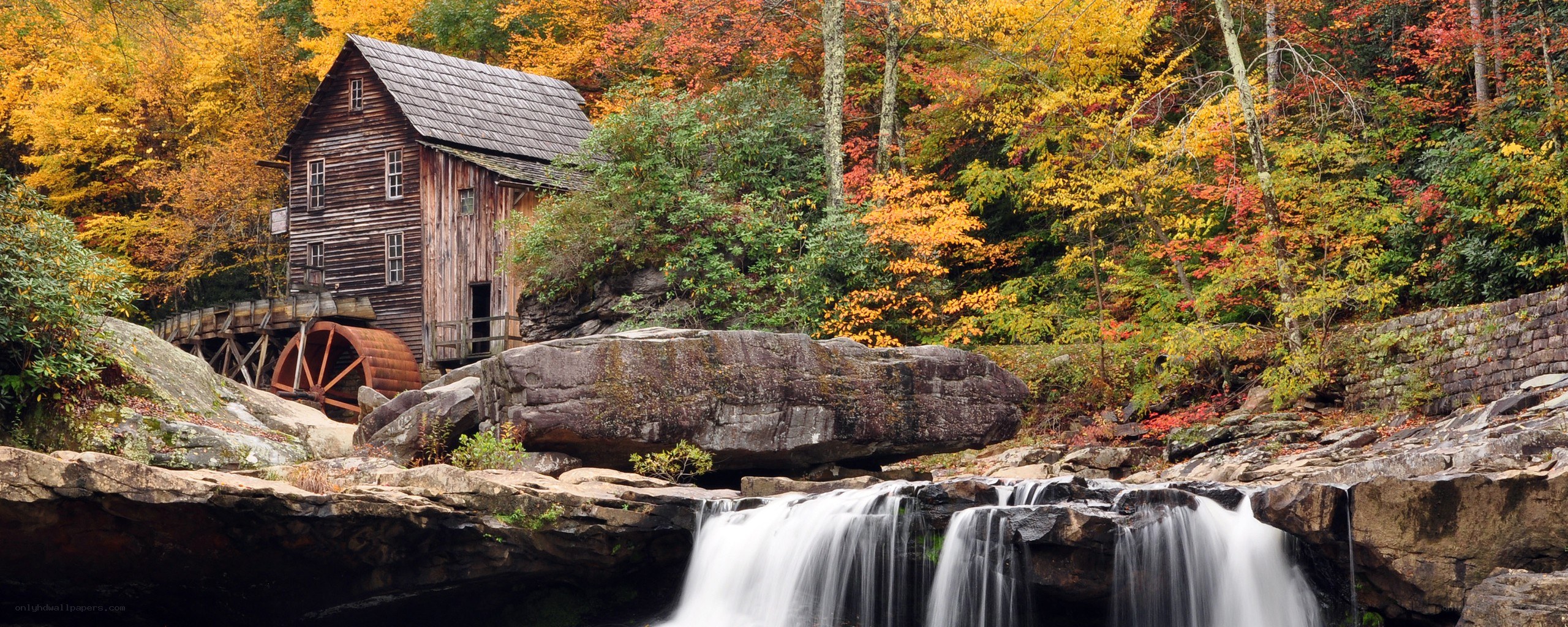 Autumn mill by a waterfall
