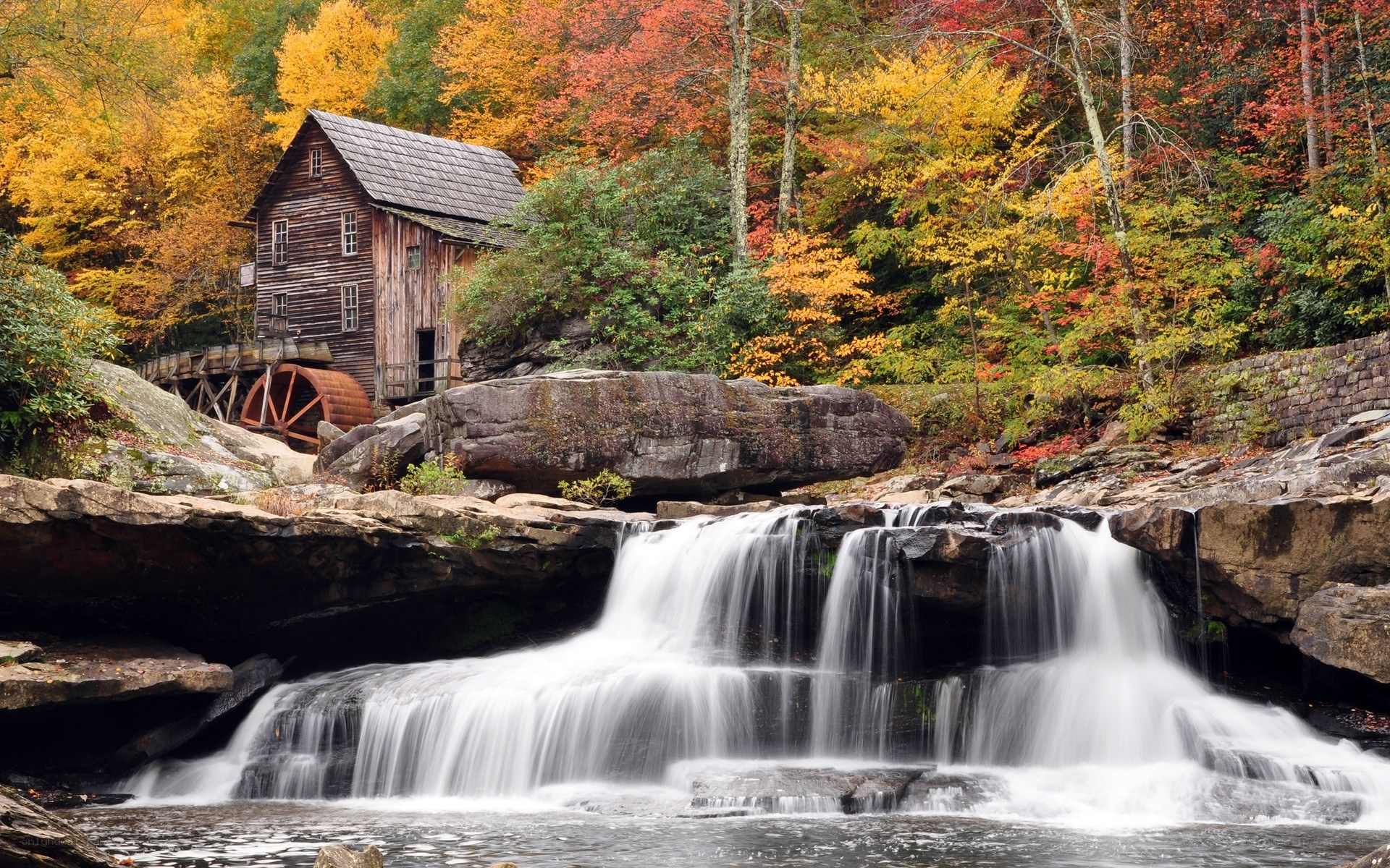 Autumn mill by a waterfall