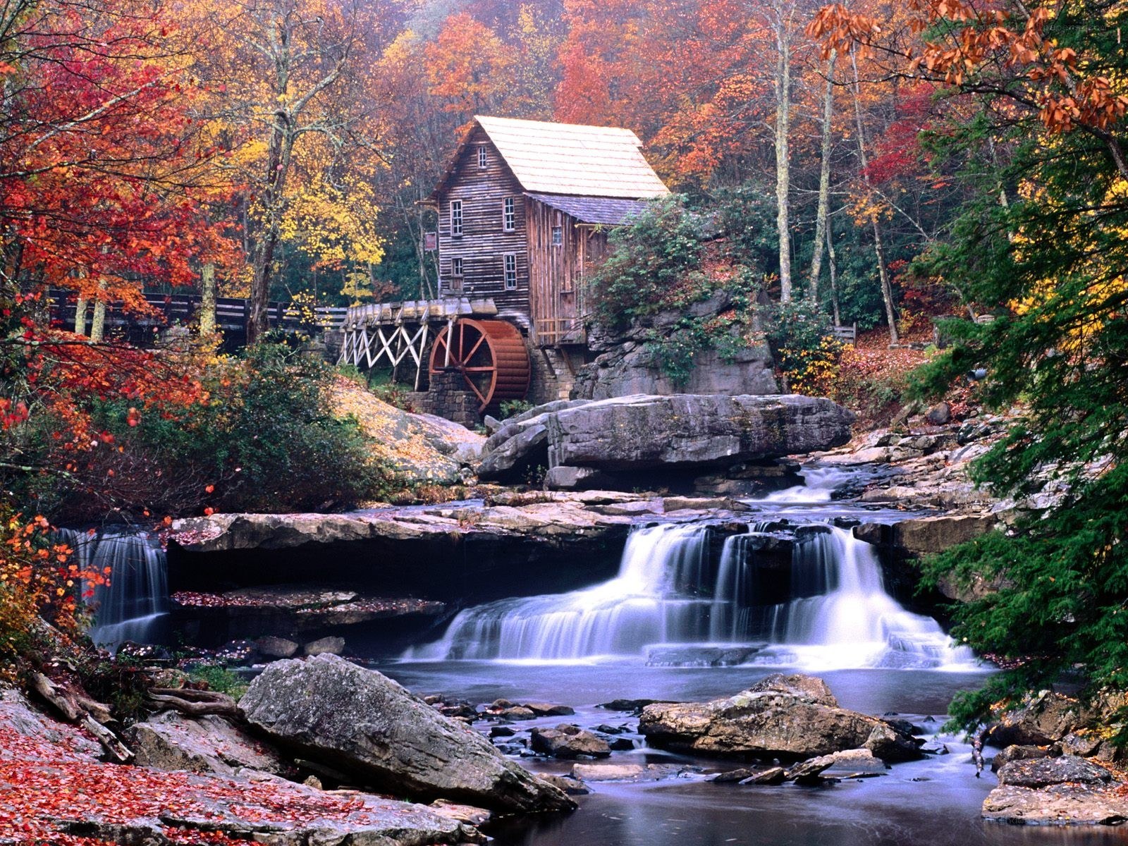Autumn mill by a waterfall