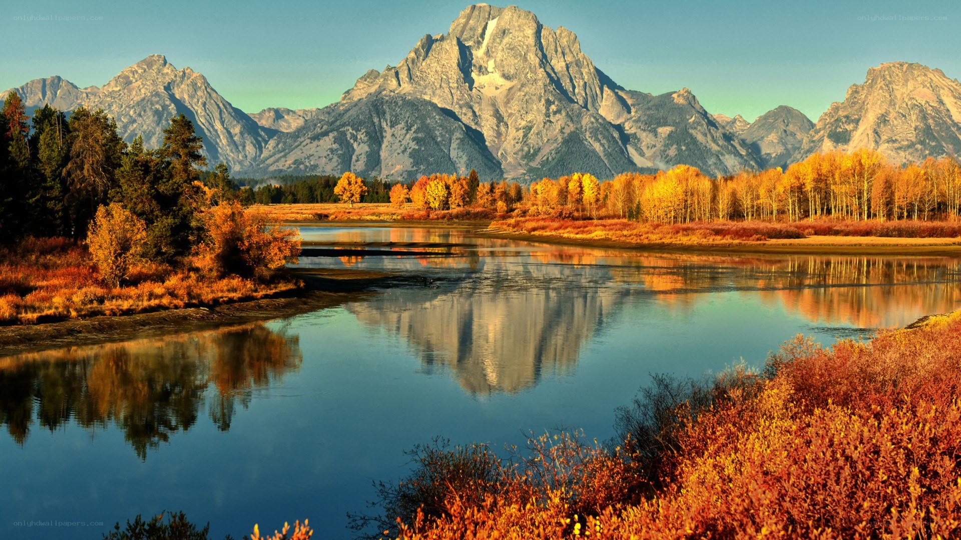 Autumn mountains reflected in a river