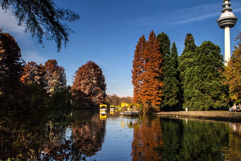 Autumn park with boats and tower
