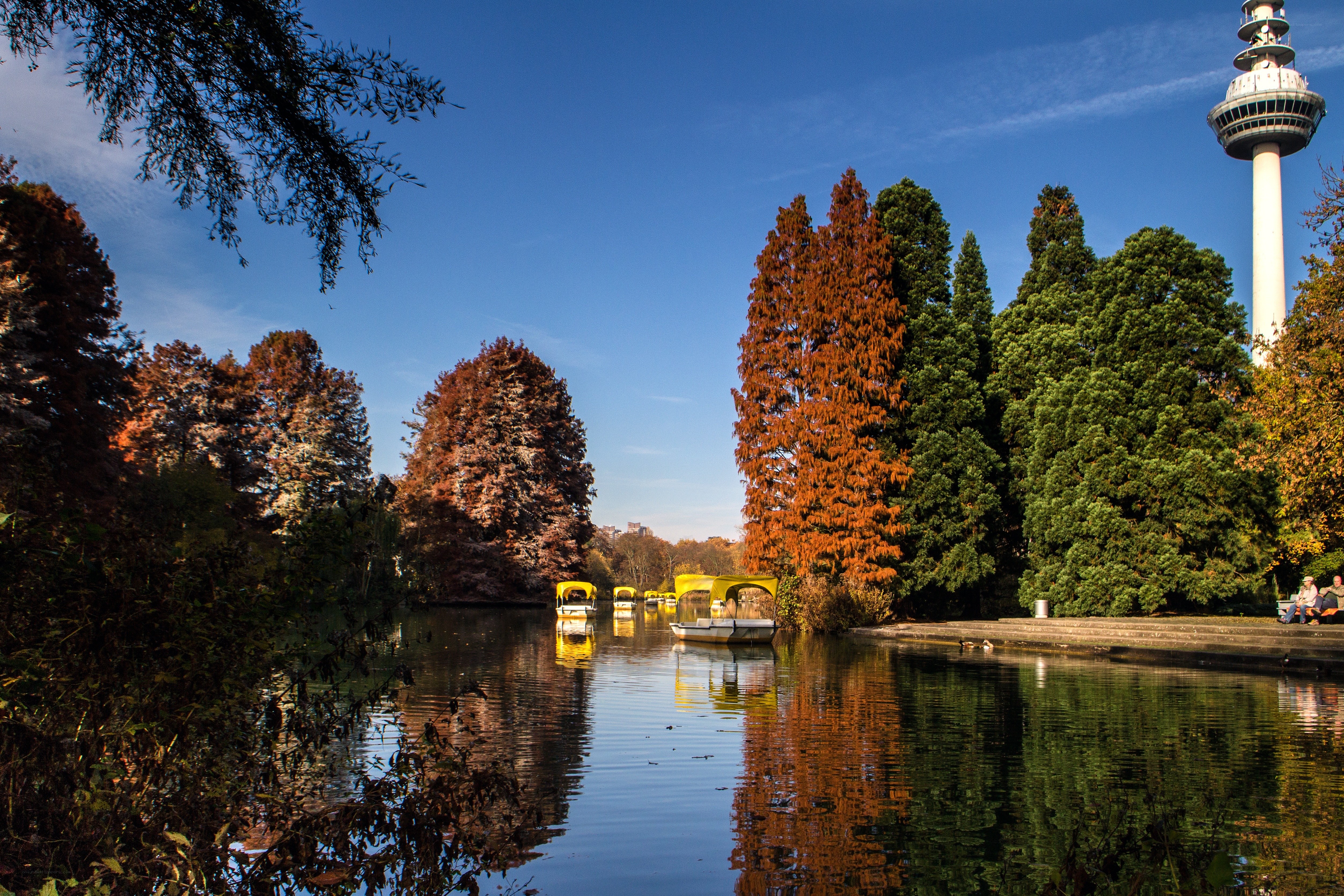 Autumn park with boats and tower
