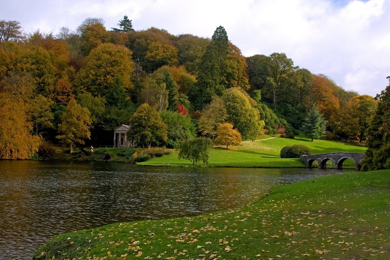 Autumn park with lake and bridge