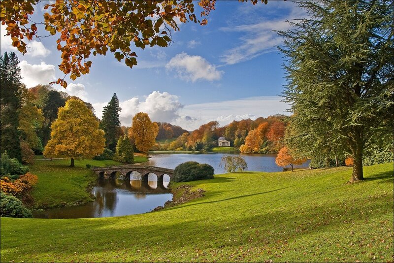 Autumn park with lake and bridge