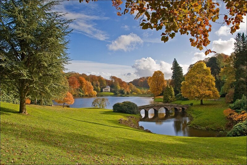 Autumn park with lake and bridge