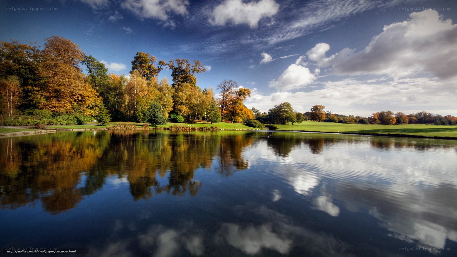 Autumn park with lake reflection