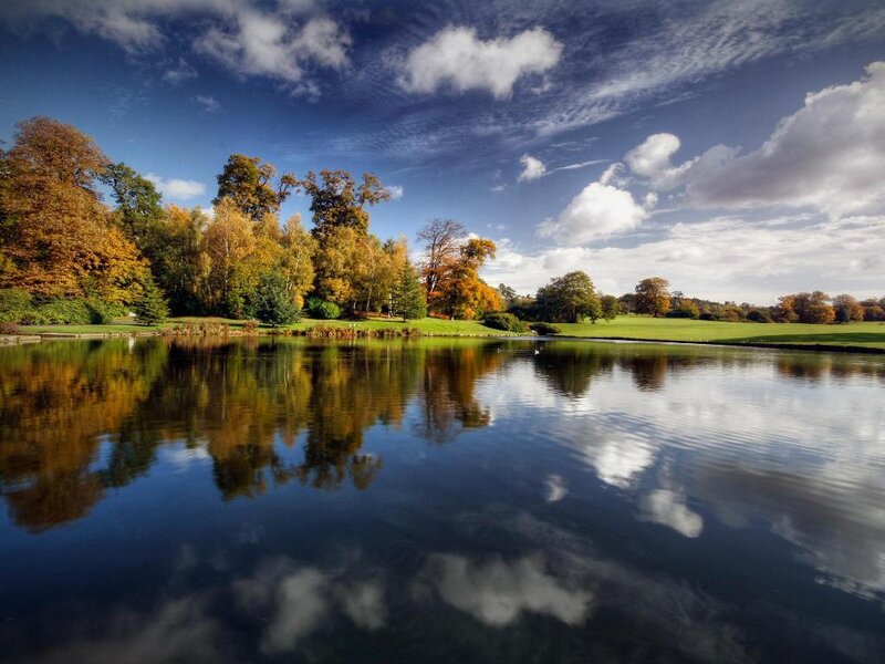 Autumn park with lake reflection
