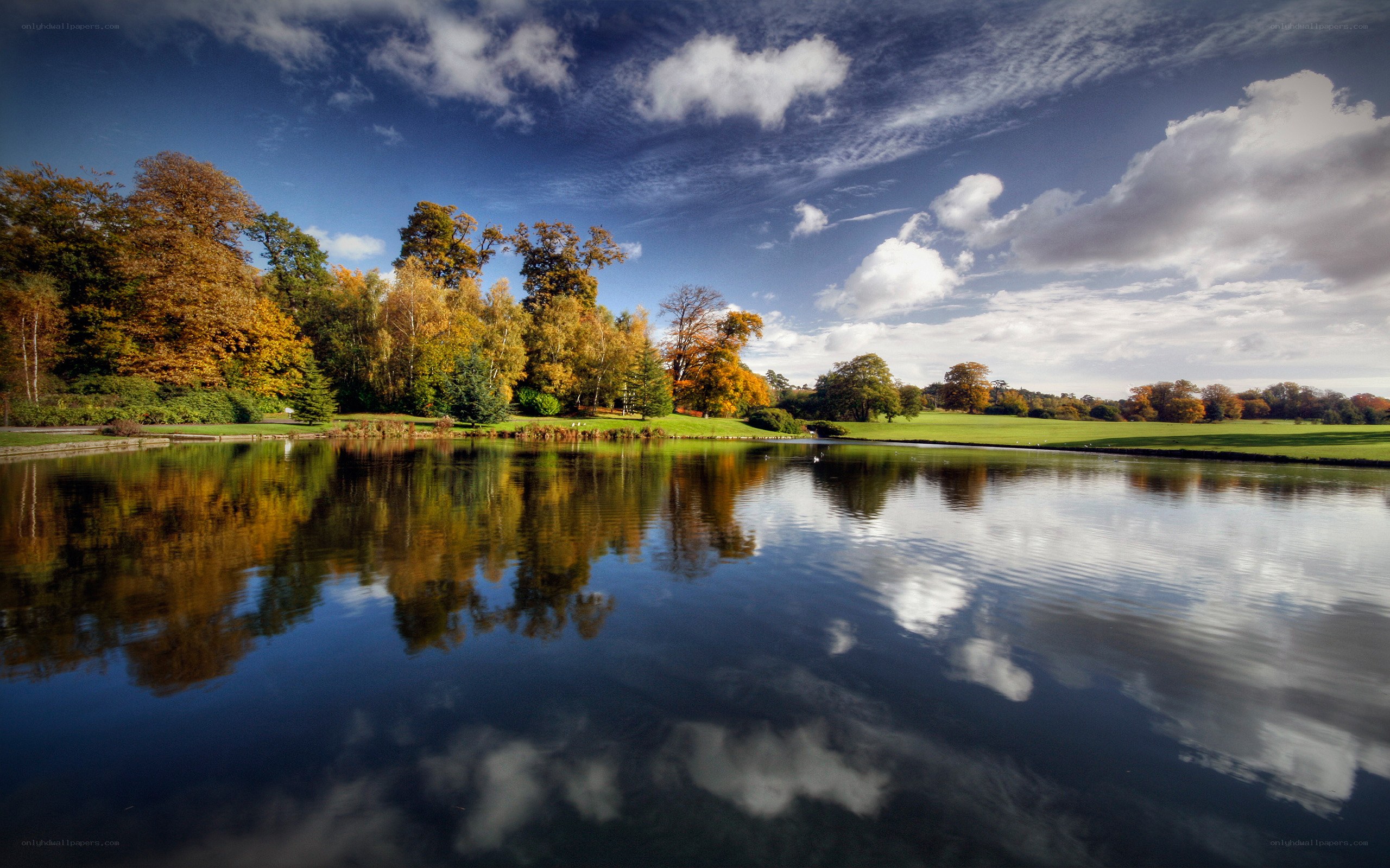 Autumn park with lake reflection
