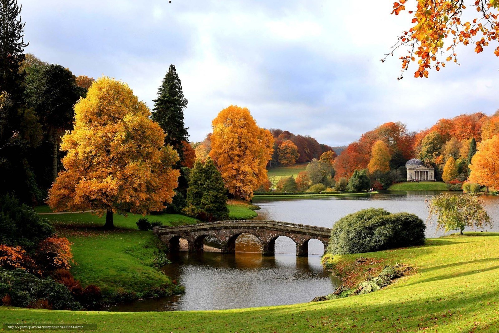 Autumn park with stone bridge