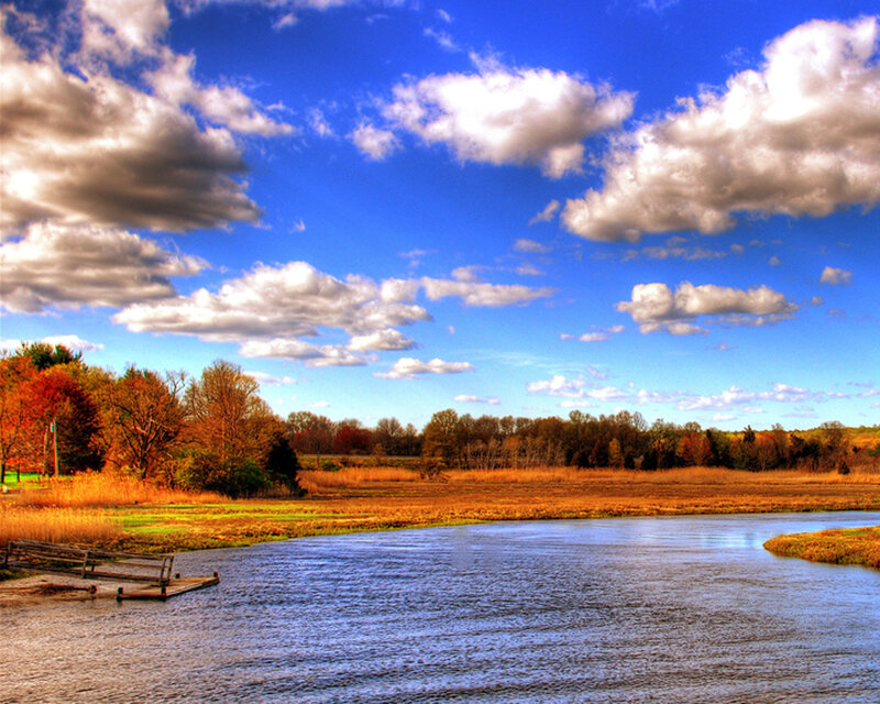 Autumn river landscape with dock