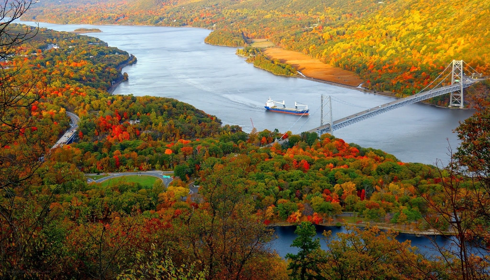 Autumn river with bridge and ship
