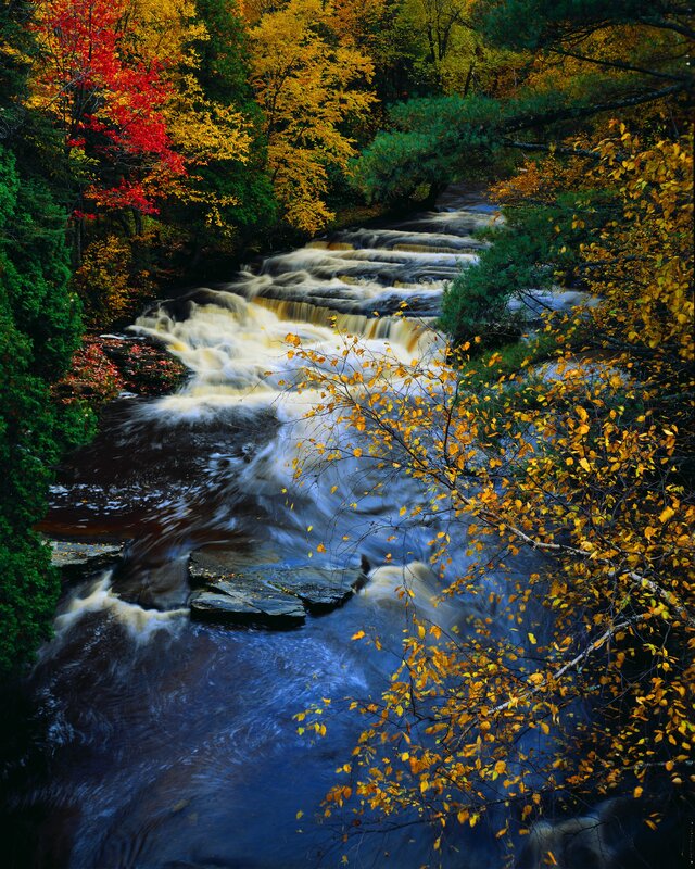 Autumn river with cascading waterfalls