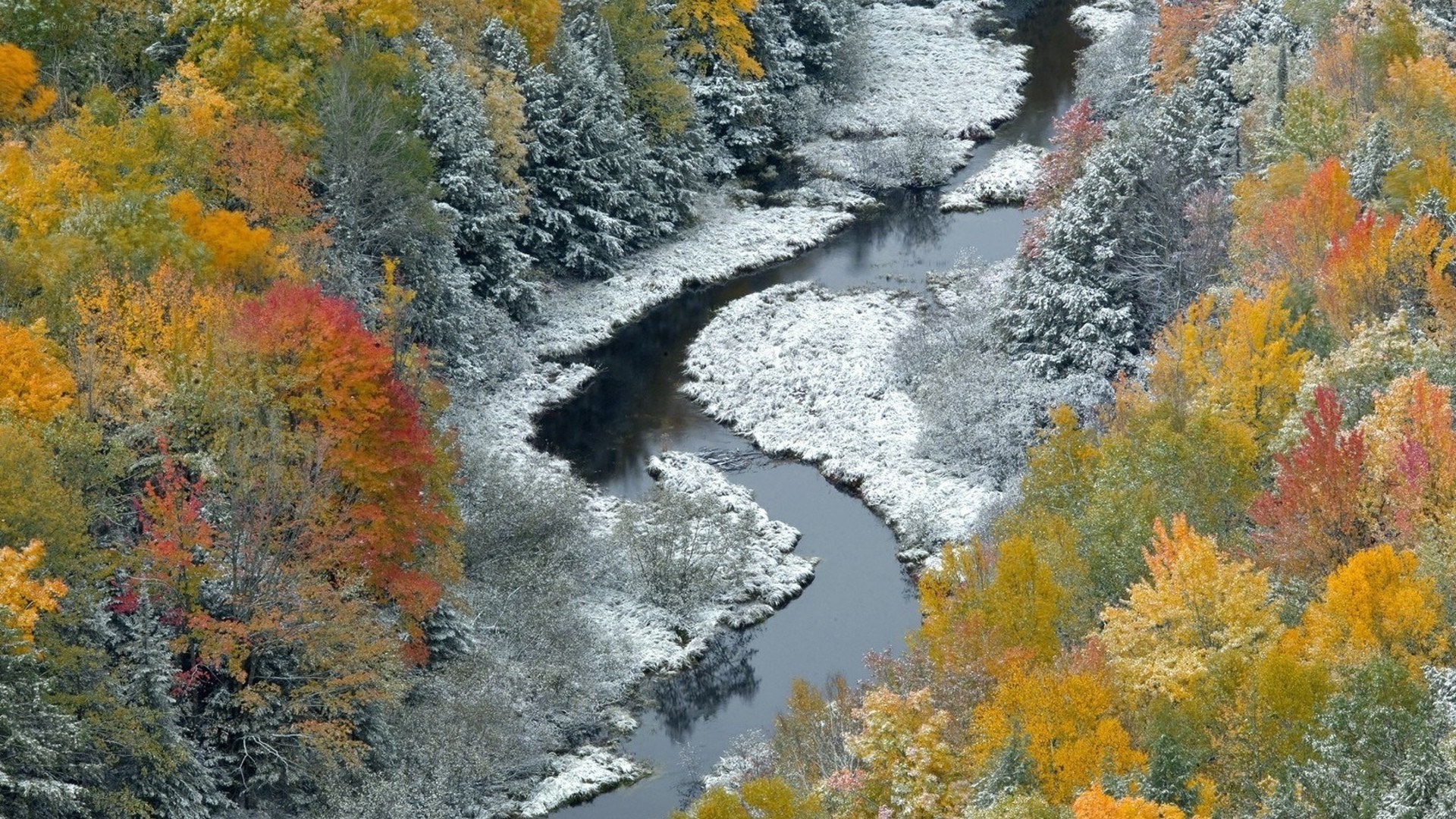 Autumn river with light snow
