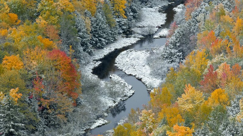 Autumn river with light snow