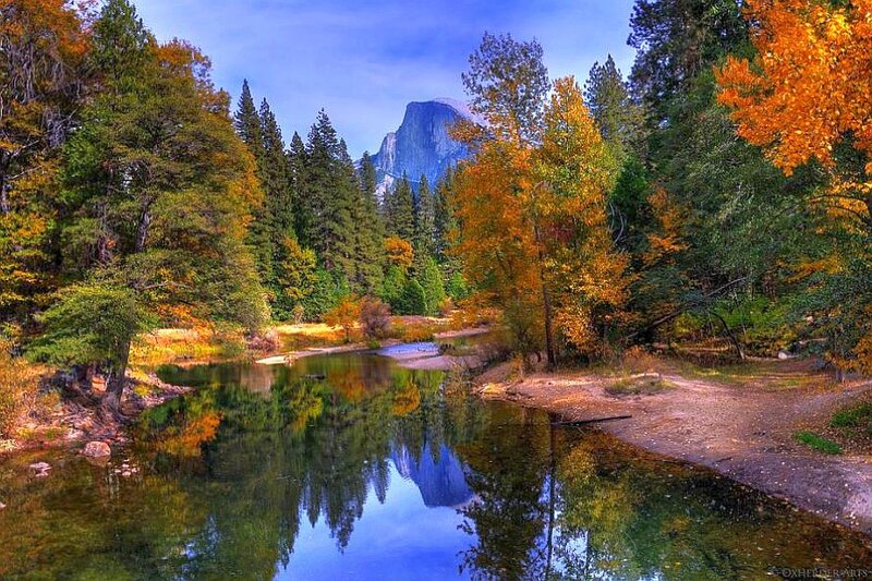 Autumn river with mountain reflection