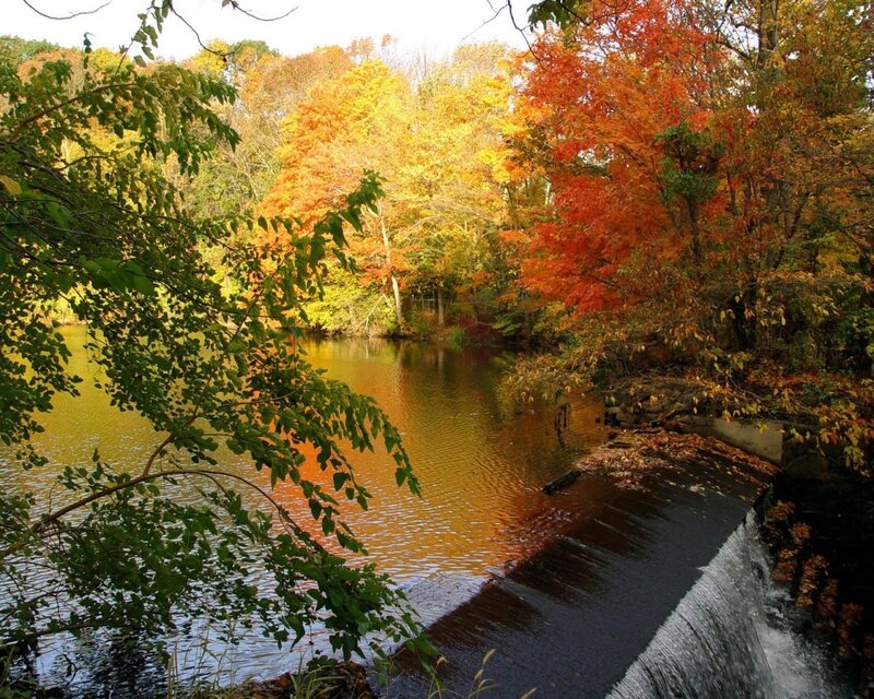 Autumn river with small waterfall