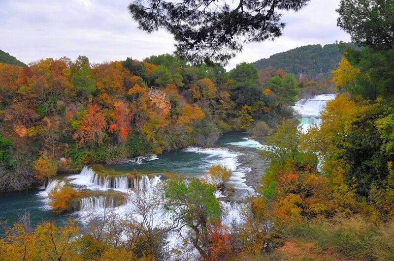 autumn river with waterfalls