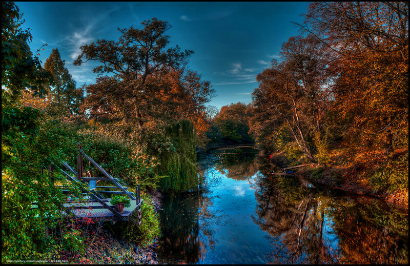 Autumn river with wooden dock