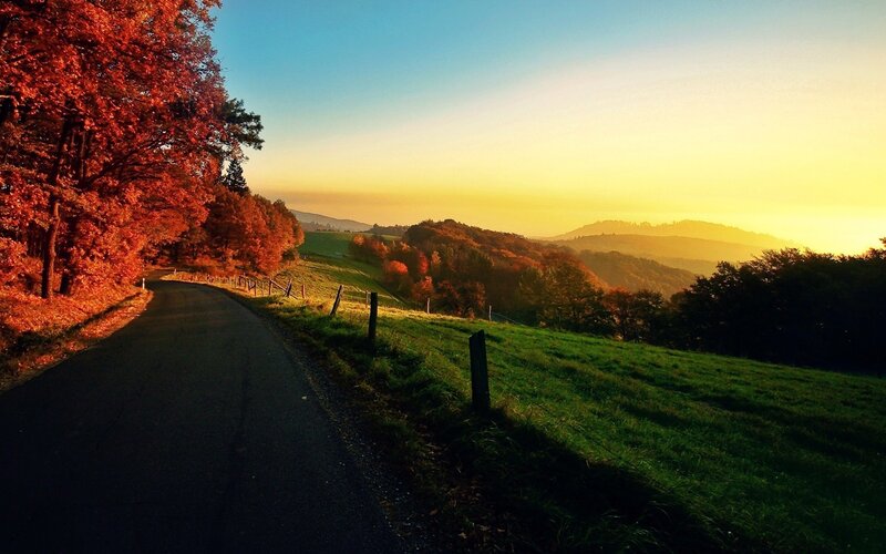 Autumn road at sunset