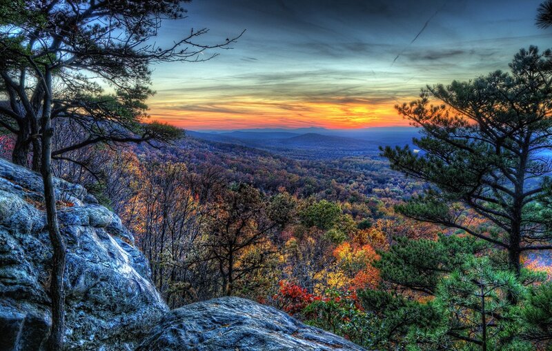 Autumn sunset over forest valley