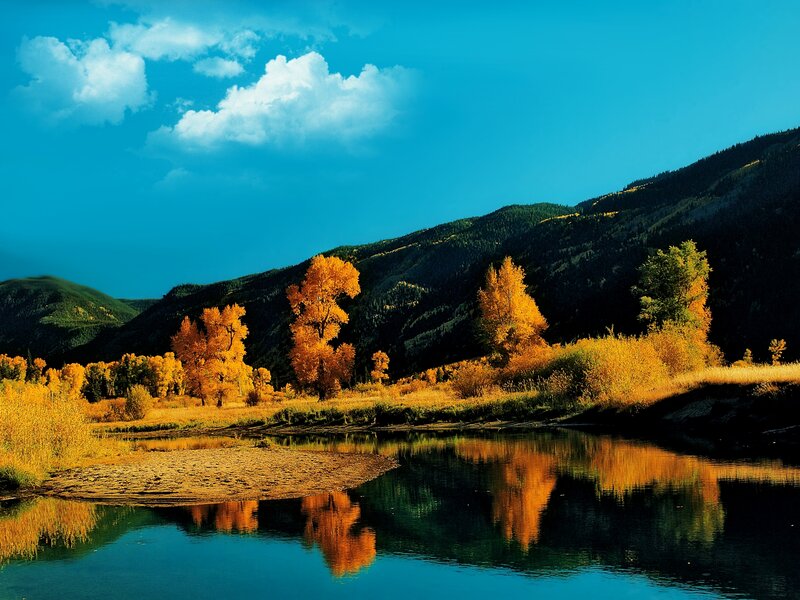 Autumn Trees by River — Blue, Serene, Photograph, Mountains, Clouds