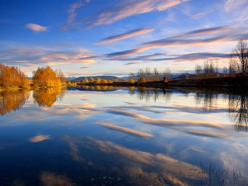 Autumn Trees Reflecting in Lake — Blue, Serene, Sunset, Photograph, Mountains, Clouds