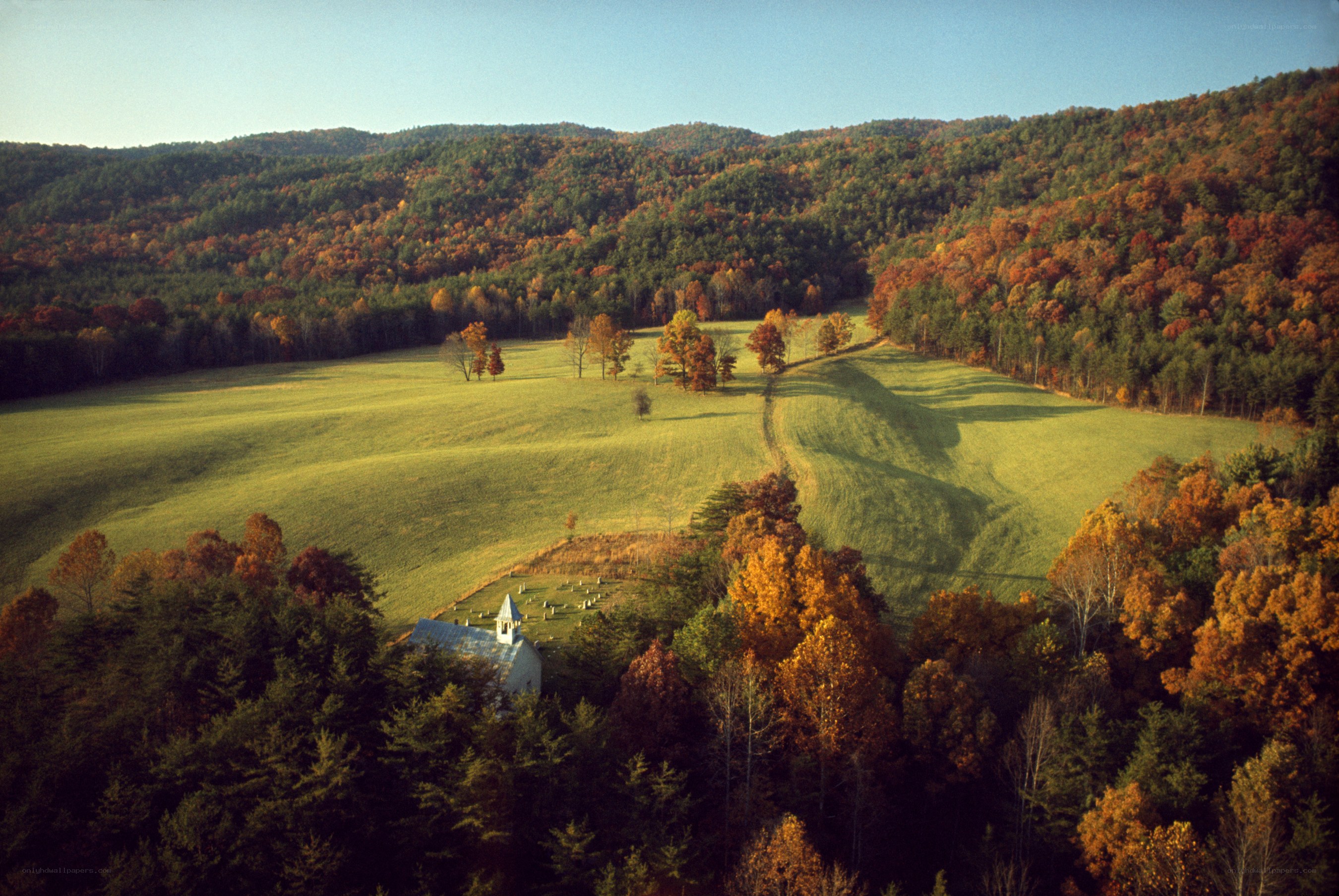 Autumn valley with chapel