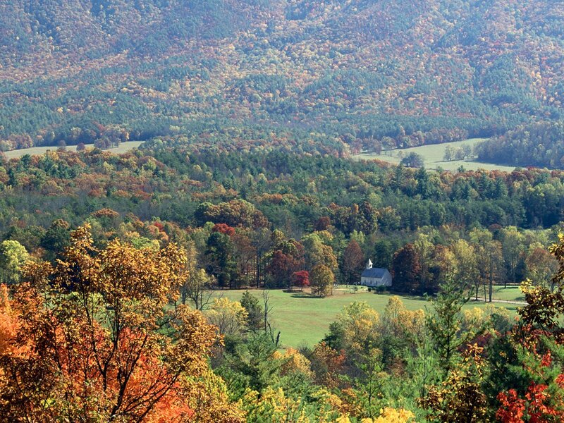 Autumn valley with church