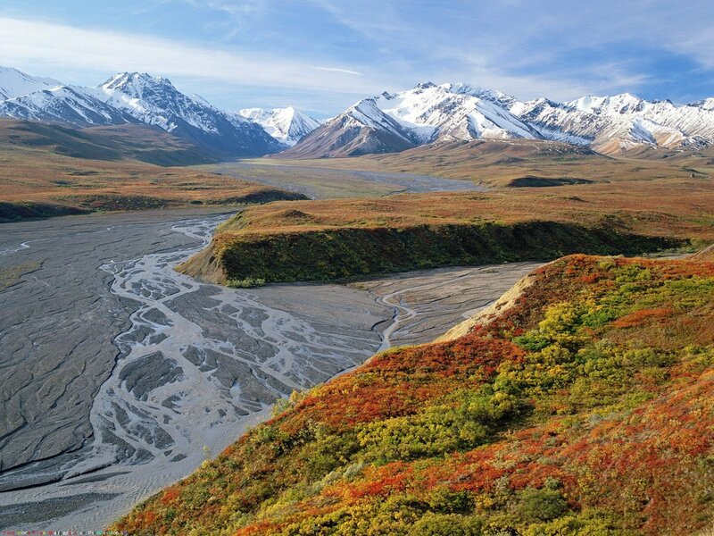 Autumn valley with snow-capped mountains