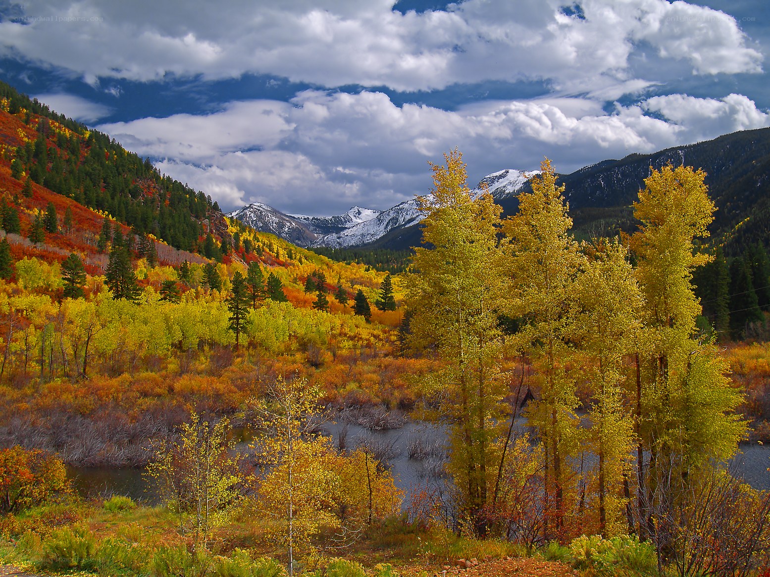 Autumn valley with snow-capped mountains