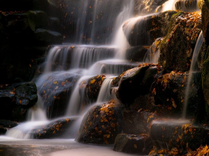 Autumn waterfall on rocks