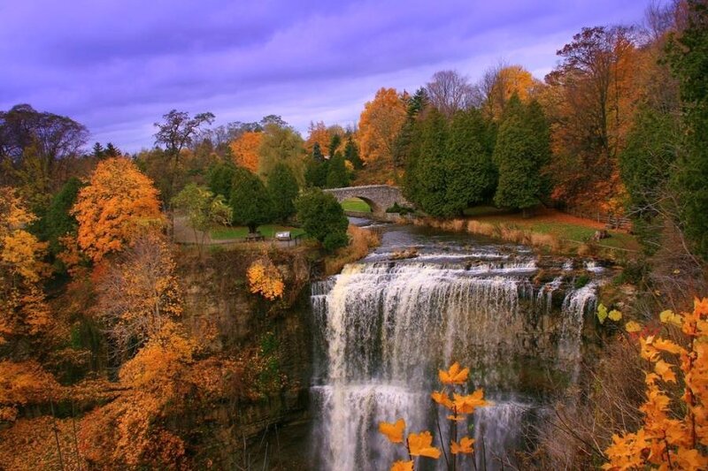 Autumn waterfall with stone bridge