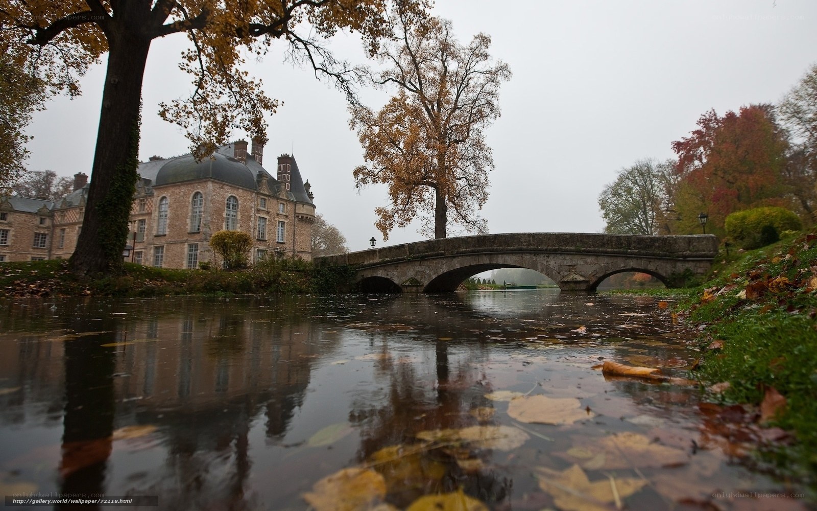 Autumnal chateau with stone bridge