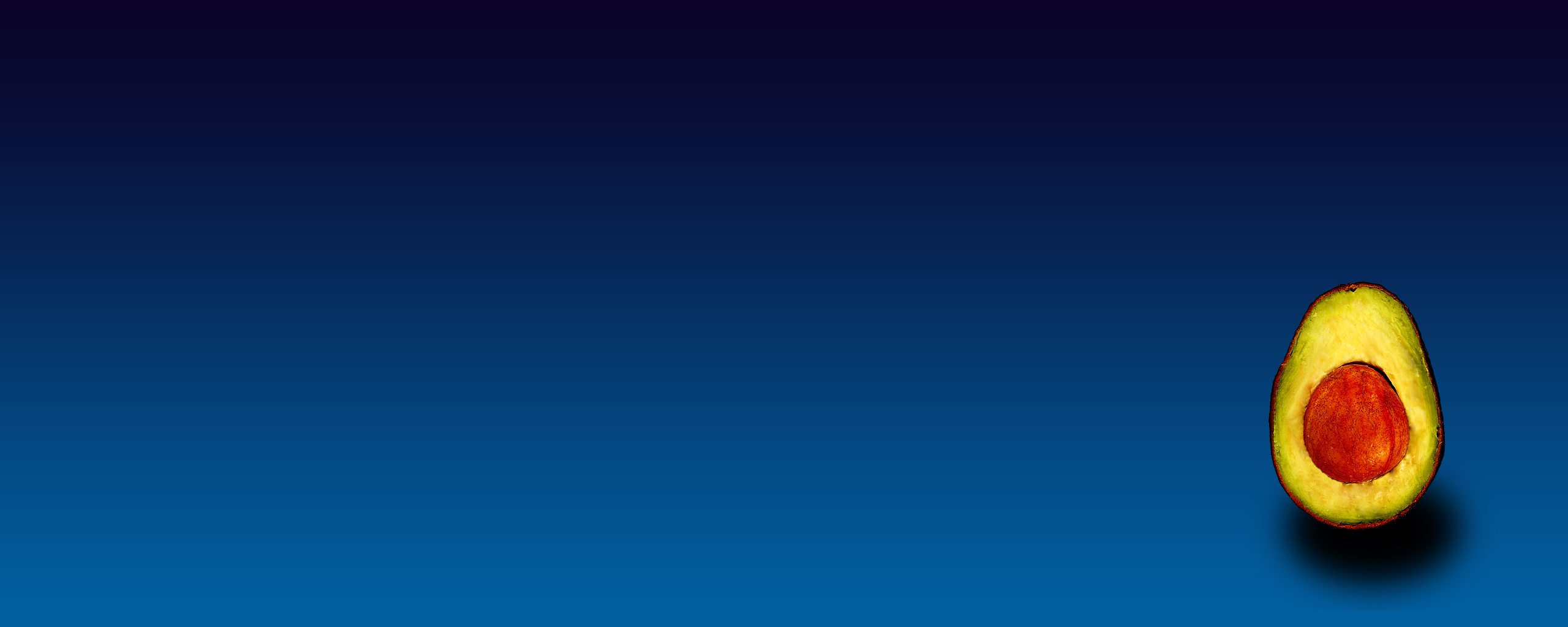 avocado half on blue background
