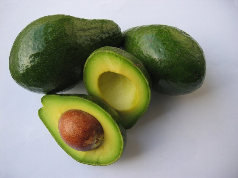 Avocados on a white surface