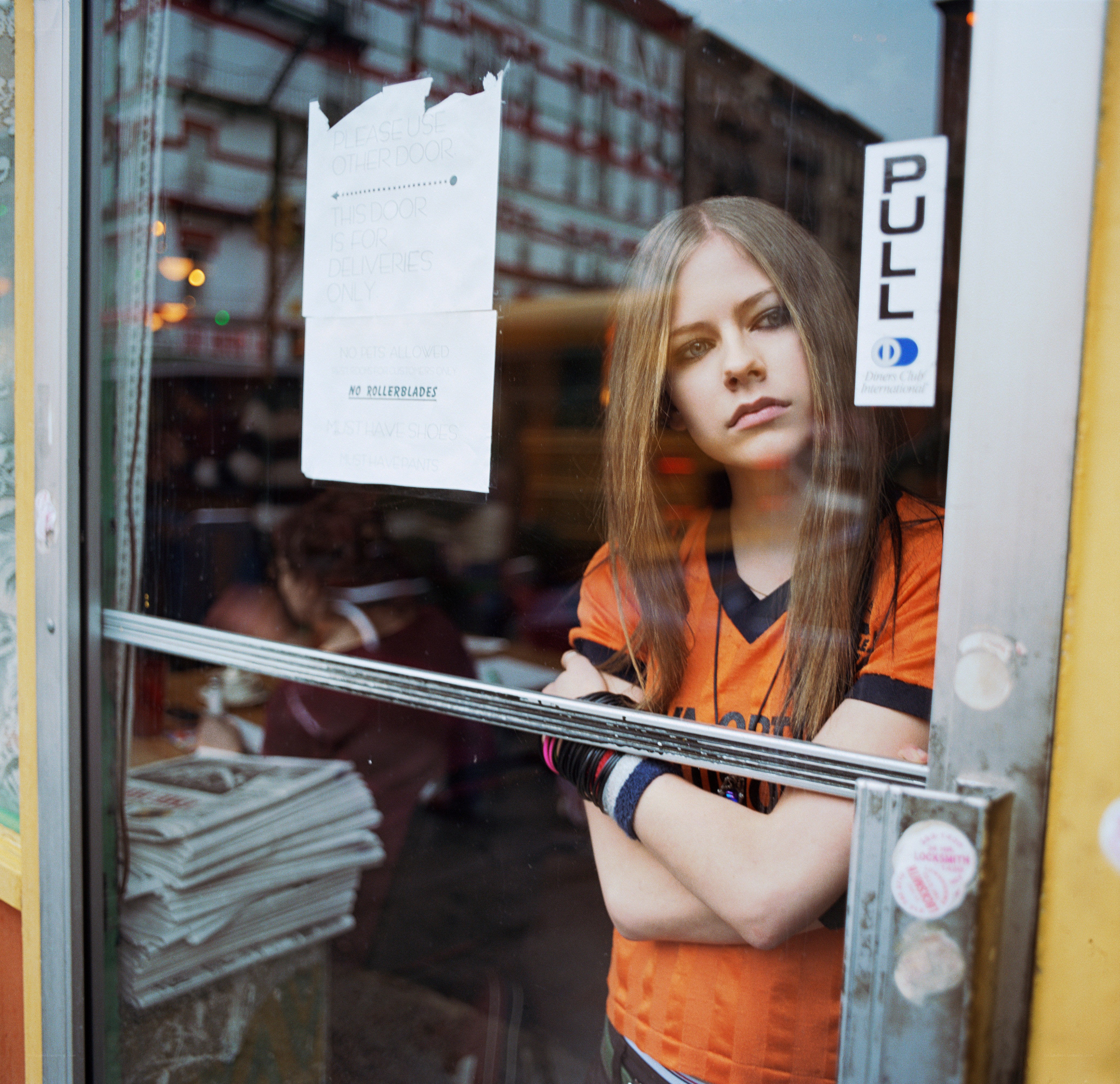 Avril Lavigne at a cafe window