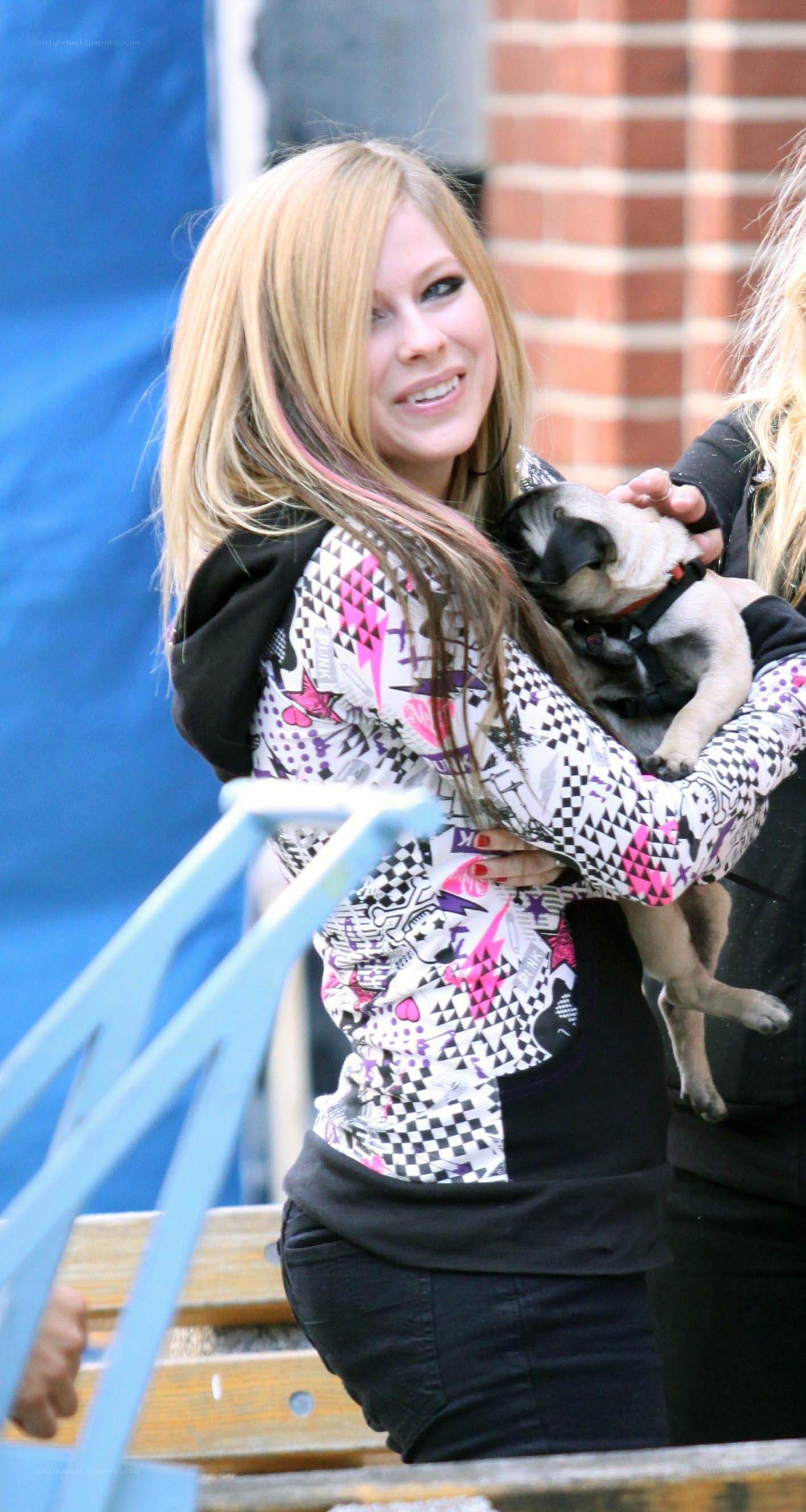 Avril Lavigne holding a pug