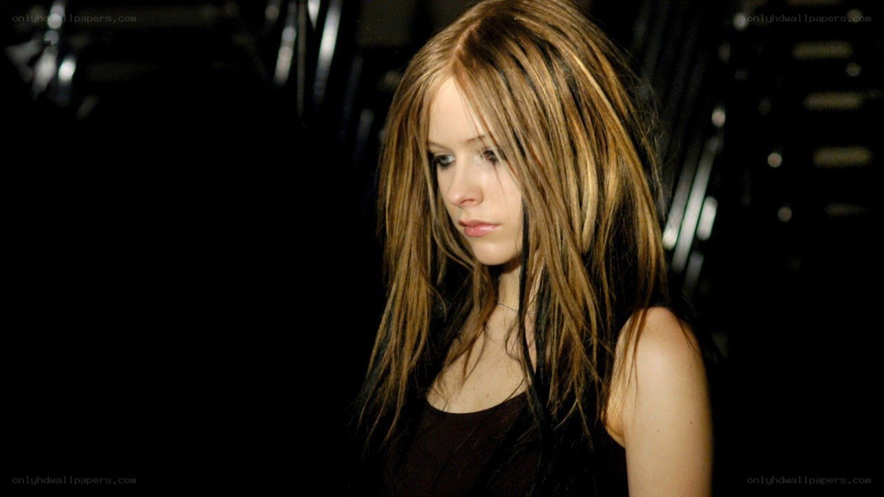 Avril Lavigne in a dark setting