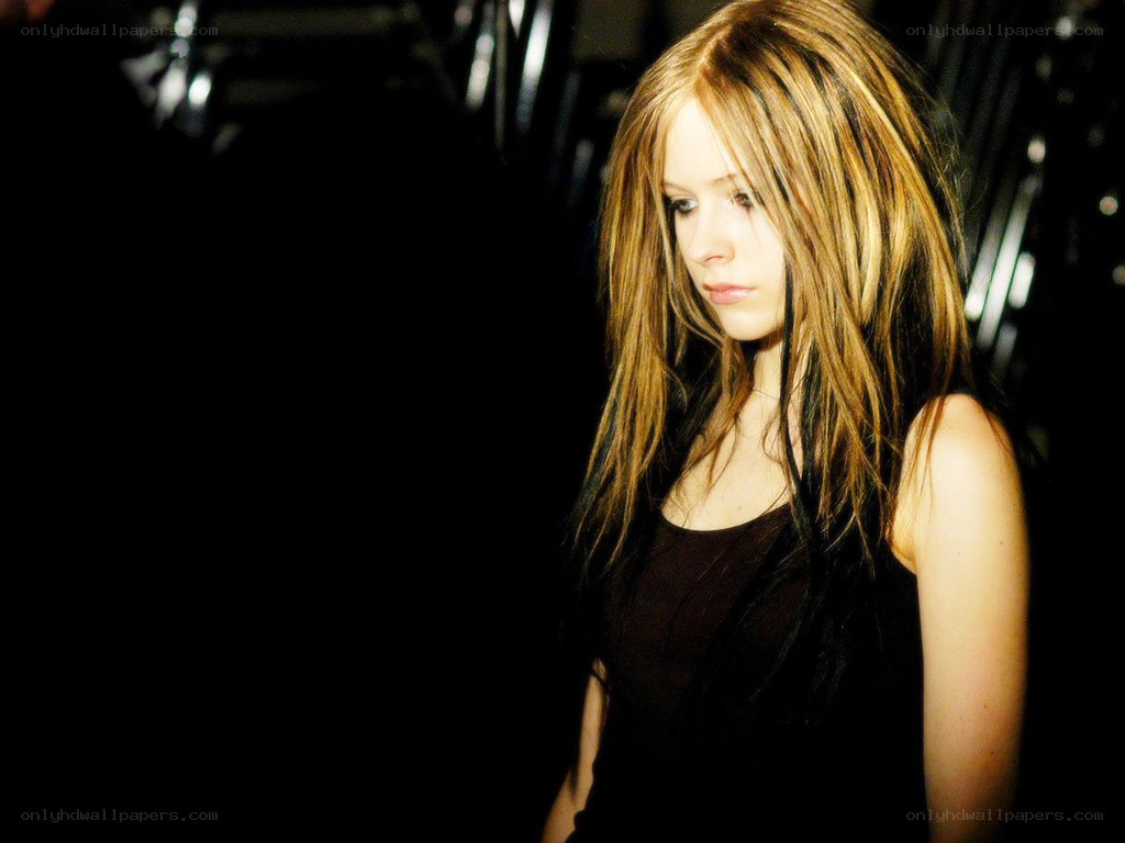 Avril Lavigne in a dark setting