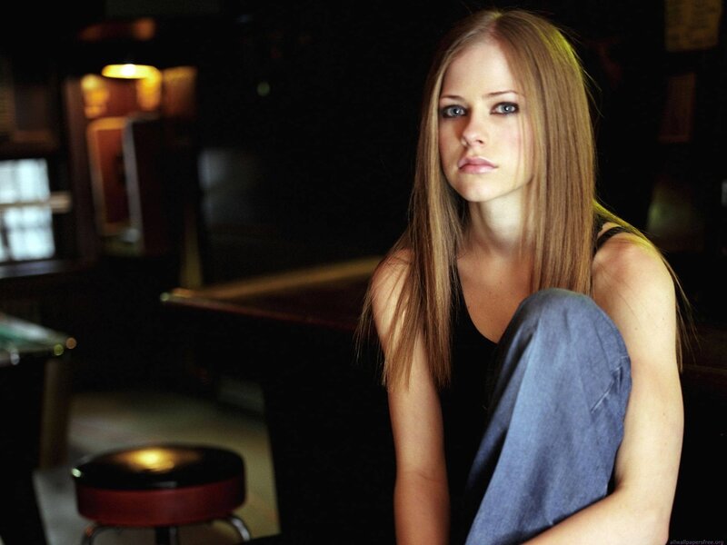 Avril Lavigne in a dimly lit room
